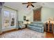 Comfortable living room featuring vaulted ceilings, a decorative ceiling fan and an outdoor view at 221 Saddle Ridge Rd, Chapel Hill, NC 27514