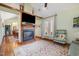 Cozy living room with a beautiful fireplace, hardwood floors, and view into the dining room at 221 Saddle Ridge Rd, Chapel Hill, NC 27514
