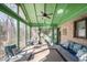 Inviting screened porch furnished with comfortable seating, brick accents, and a ceiling fan at 221 Saddle Ridge Rd, Chapel Hill, NC 27514