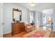Sitting area has a dresser with a mirror, chair with accent pillows, and hardwood floors at 221 Saddle Ridge Rd, Chapel Hill, NC 27514