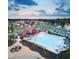 Aerial view of a community pool with a barn-style clubhouse and surrounding neighborhood homes at 270 Inspiration Way Way, Fuquay Varina, NC 27526
