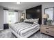 Stylish bedroom with a black accent wall, a striped bedspread, and matching nightstands and lamps at 281 Broomside Ave, Raleigh, NC 27603