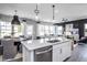 Open-concept kitchen with stainless steel appliances, granite countertops, and breakfast bar seating at 281 Broomside Ave, Raleigh, NC 27603
