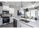 Bright kitchen featuring white cabinets, granite countertops, and stainless steel appliances at 281 Broomside Ave, Raleigh, NC 27603