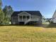 Home's backyard showcasing a covered back porch, stair access to the yard, and irrigation at 309 Deer Tail Ln # 42, Fuquay Varina, NC 27526
