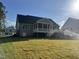 Expansive backyard featuring a covered deck, newly installed grass and irrigation at 309 Deer Tail Ln # 42, Fuquay Varina, NC 27526