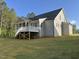 Exterior view of the home with a covered back porch and a lush green lawn at 309 Deer Tail Ln # 42, Fuquay Varina, NC 27526
