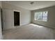 Bedroom featuring neutral paint, trim, and large window at 309 Deer Tail Ln # 42, Fuquay Varina, NC 27526
