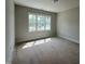Bedroom featuring neutral paint, trim, and large window at 309 Deer Tail Ln # 42, Fuquay Varina, NC 27526