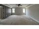 A spacious bedroom with a window, fan, and neutral walls at 309 Deer Tail Ln # 42, Fuquay Varina, NC 27526