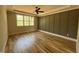 Large bedroom featuring a ceiling fan, hardwood floors, green accent walls, and natural light at 309 Deer Tail Ln # 42, Fuquay Varina, NC 27526