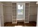 A walk-in closet offers custom built-in shelving, a window, and ample storage space at 309 Deer Tail Ln # 42, Fuquay Varina, NC 27526