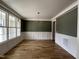 Open dining room with hardwood floors, white wainscoting and stylish light fixture at 309 Deer Tail Ln # 42, Fuquay Varina, NC 27526