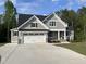 Beautiful two-story home featuring gray siding, black roof, and a three-car garage with a concrete driveway at 309 Deer Tail Ln # 42, Fuquay Varina, NC 27526