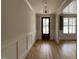 Bright foyer with hardwood floors, wainscoting, stylish light fixture, and a view of the outdoors at 309 Deer Tail Ln # 42, Fuquay Varina, NC 27526