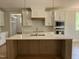 Spacious kitchen with an island, stainless appliances, white cabinets, and wooden accents at 309 Deer Tail Ln # 42, Fuquay Varina, NC 27526