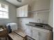Laundry room featuring white cabinets, light gray countertops, and natural light at 309 Deer Tail Ln # 42, Fuquay Varina, NC 27526