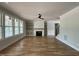 Cozy living room featuring a fireplace, custom built-ins, hardwood floors, and abundant natural light at 309 Deer Tail Ln # 42, Fuquay Varina, NC 27526