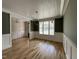 Spacious living room with dark green accent walls, wainscotting, and hardwood floors at 309 Deer Tail Ln # 42, Fuquay Varina, NC 27526