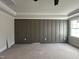 Main bedroom wall featuring hidden door with decorative paneling at 309 Deer Tail Ln # 42, Fuquay Varina, NC 27526