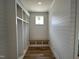 Mudroom featuring custom shelving, wooden floors, white shiplap walls, and natural light at 309 Deer Tail Ln # 42, Fuquay Varina, NC 27526