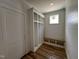 Mudroom featuring custom shelving, wooden floors, white shiplap walls, and natural light at 309 Deer Tail Ln # 42, Fuquay Varina, NC 27526
