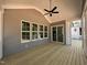 Covered porch with ceiling fan, multiple windows, and access to the backyard at 309 Deer Tail Ln # 42, Fuquay Varina, NC 27526