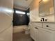 Bathroom features a tub with a dark tiled backsplash, a vanity with a dark faucet, and a framed mirror at 318 Deer Tail Ln # 35, Fuquay Varina, NC 27526
