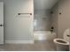 Tiled bathroom with a tub and shower combination with black hardware at 318 Deer Tail Ln # 35, Fuquay Varina, NC 27526