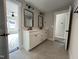 Bathroom with double vanities, framed mirrors, and tiled floors at 318 Deer Tail Ln # 35, Fuquay Varina, NC 27526