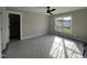 Bright bedroom featuring a ceiling fan and a view of the outdoors through a large window at 318 Deer Tail Ln # 35, Fuquay Varina, NC 27526