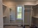 Spacious walk-in closet featuring custom shelving, a large window, and a full-length mirror at 318 Deer Tail Ln # 35, Fuquay Varina, NC 27526