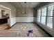 Spacious dining room with wainscoting, decorative chandelier, and large windows offering plenty of natural light at 318 Deer Tail Ln # 35, Fuquay Varina, NC 27526