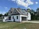 Beautiful modern house boasts an attached garage with an open entrance and a well-manicured lawn leading up to the structure at 318 Deer Tail Ln # 35, Fuquay Varina, NC 27526