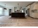 Modern kitchen featuring a central island with dark cabinets and a contrasting countertop, open to a bright, airy space at 318 Deer Tail Ln # 35, Fuquay Varina, NC 27526