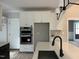 Modern kitchen features stainless steel appliances, white cabinets, a black sink, and a quartz countertop at 318 Deer Tail Ln # 35, Fuquay Varina, NC 27526