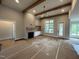 Open-concept living room features a fireplace with a decorative surround and built-in shelving, enhanced by natural light at 318 Deer Tail Ln # 35, Fuquay Varina, NC 27526