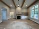 Inviting living room featuring a fireplace, wooden beams, built-in shelving, and natural light, creating a warm atmosphere at 318 Deer Tail Ln # 35, Fuquay Varina, NC 27526