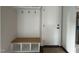 Convenient mudroom features a built-in bench with storage and coat hooks, next to a white door at 318 Deer Tail Ln # 35, Fuquay Varina, NC 27526