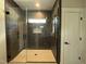 Contemporary bathroom showcasing a glass-enclosed shower with dark tile and a tiled floor at 318 Deer Tail Ln # 35, Fuquay Varina, NC 27526
