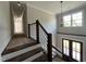 Modern staircase with dark wood steps, black rod iron railing and pendant lighting at 318 Deer Tail Ln # 35, Fuquay Varina, NC 27526