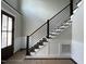 Modern staircase with dark wood steps and black rod iron railing at 318 Deer Tail Ln # 35, Fuquay Varina, NC 27526