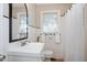 Bright bathroom features a vanity, toilet, shower with curtain, and a mirror at 326 Lake Dr, Wendell, NC 27591