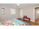 This neutral bedroom features wood floors, one window, and a red sitting bench with accent pillow at 326 Lake Dr, Wendell, NC 27591