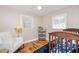 Bright Bedroom features a white accent chair, a decorative cart, and a wood crib at 326 Lake Dr, Wendell, NC 27591