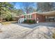 Charming brick home with a covered carport and well-maintained landscaping at 326 Lake Dr, Wendell, NC 27591