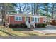 Quaint brick home featuring a tidy front yard and convenient carport at 326 Lake Dr, Wendell, NC 27591