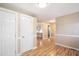 Hallway with wood flooring, neutral walls and doors to storage at 326 Lake Dr, Wendell, NC 27591