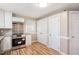 Updated kitchen with stainless steel range, white cabinets, and modern backsplash at 326 Lake Dr, Wendell, NC 27591