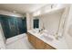 Elegant bathroom with a double sink vanity, stylish lighting, and a walk-in shower with glass doors at 3930 Willow Gate Way, Raleigh, NC 27604
